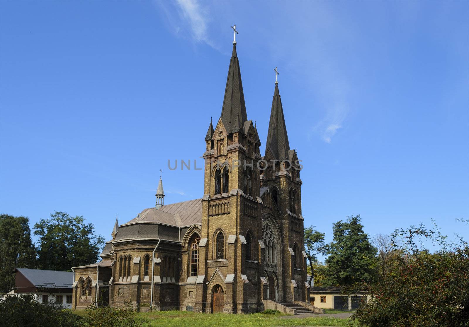 Common front-side view of the Catholic church in the summer sunlight.