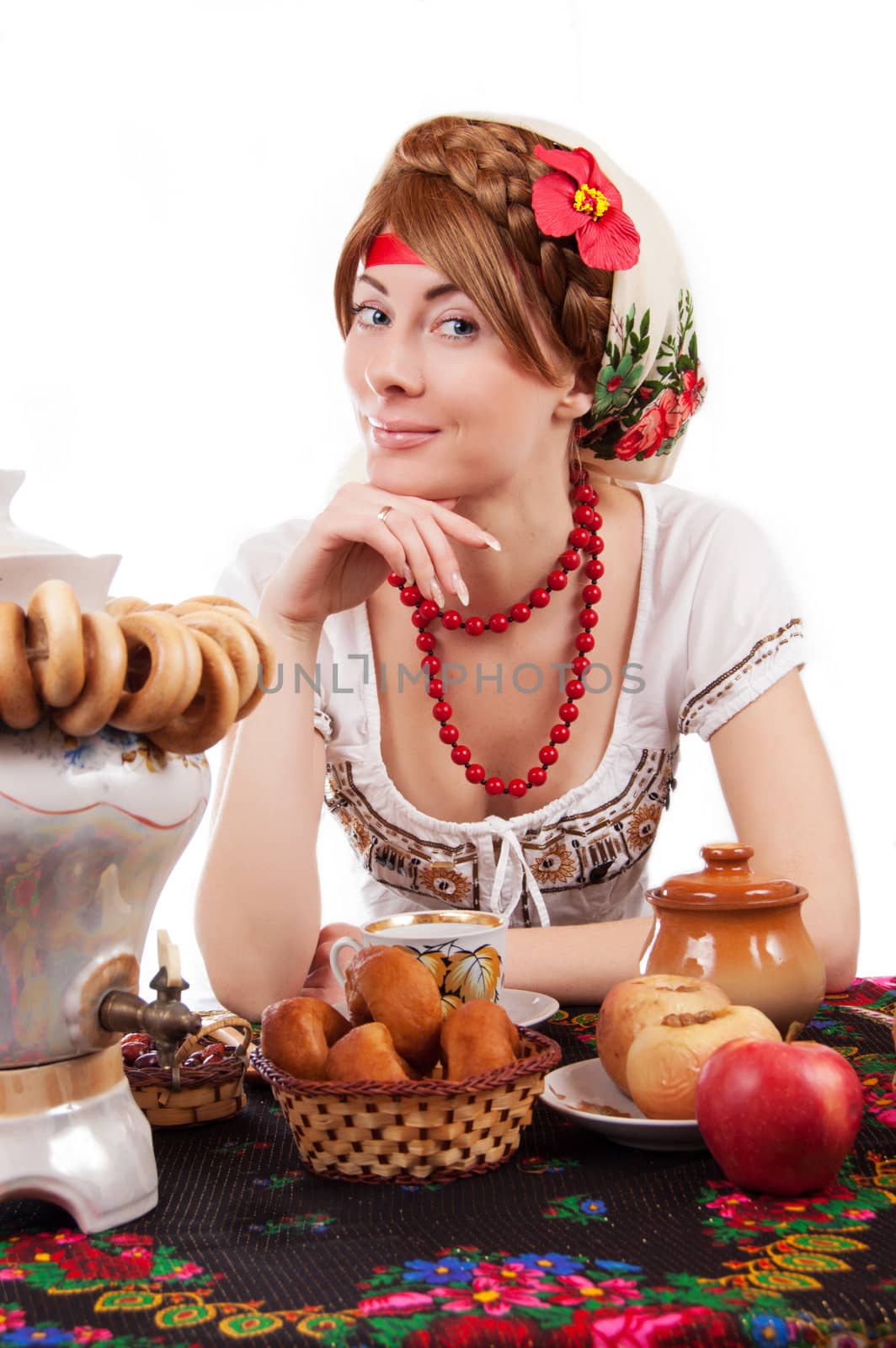 Hospitable russian woman welcomes to drinking tea with samovar over white
