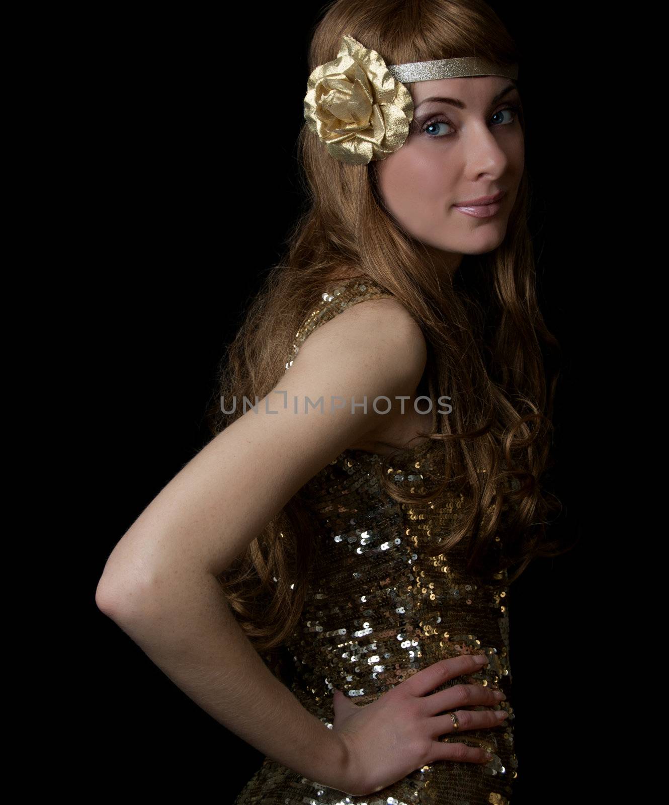 Retro-styled woman in golden dress over black