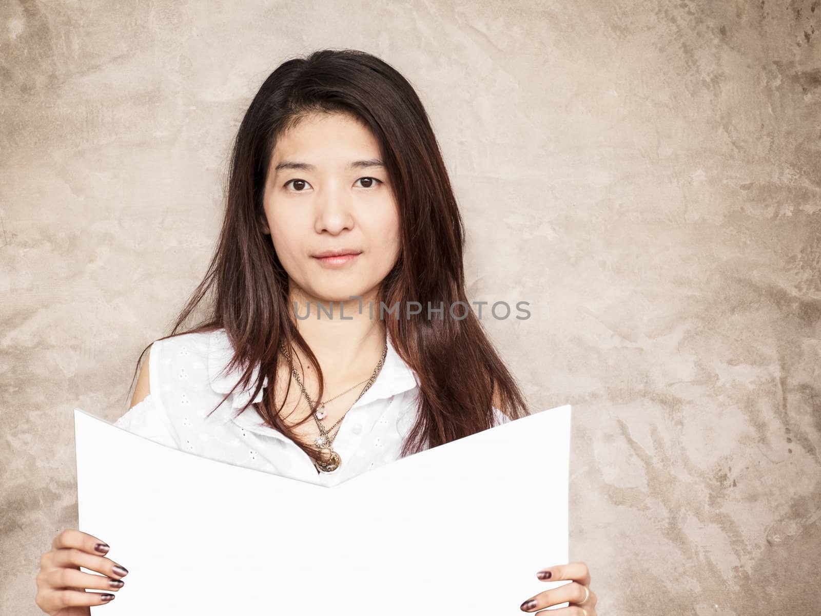 young woman reading book or magazine