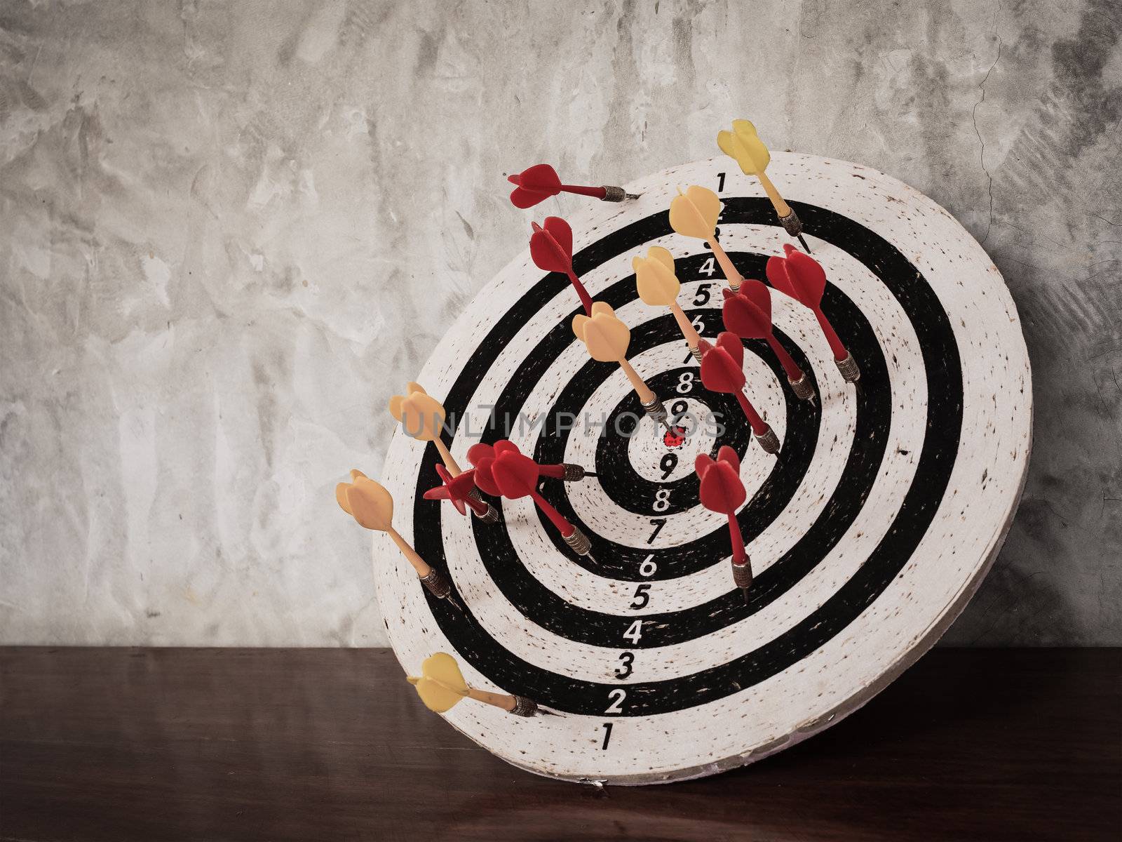 Success concept, darts hit target on dartboard