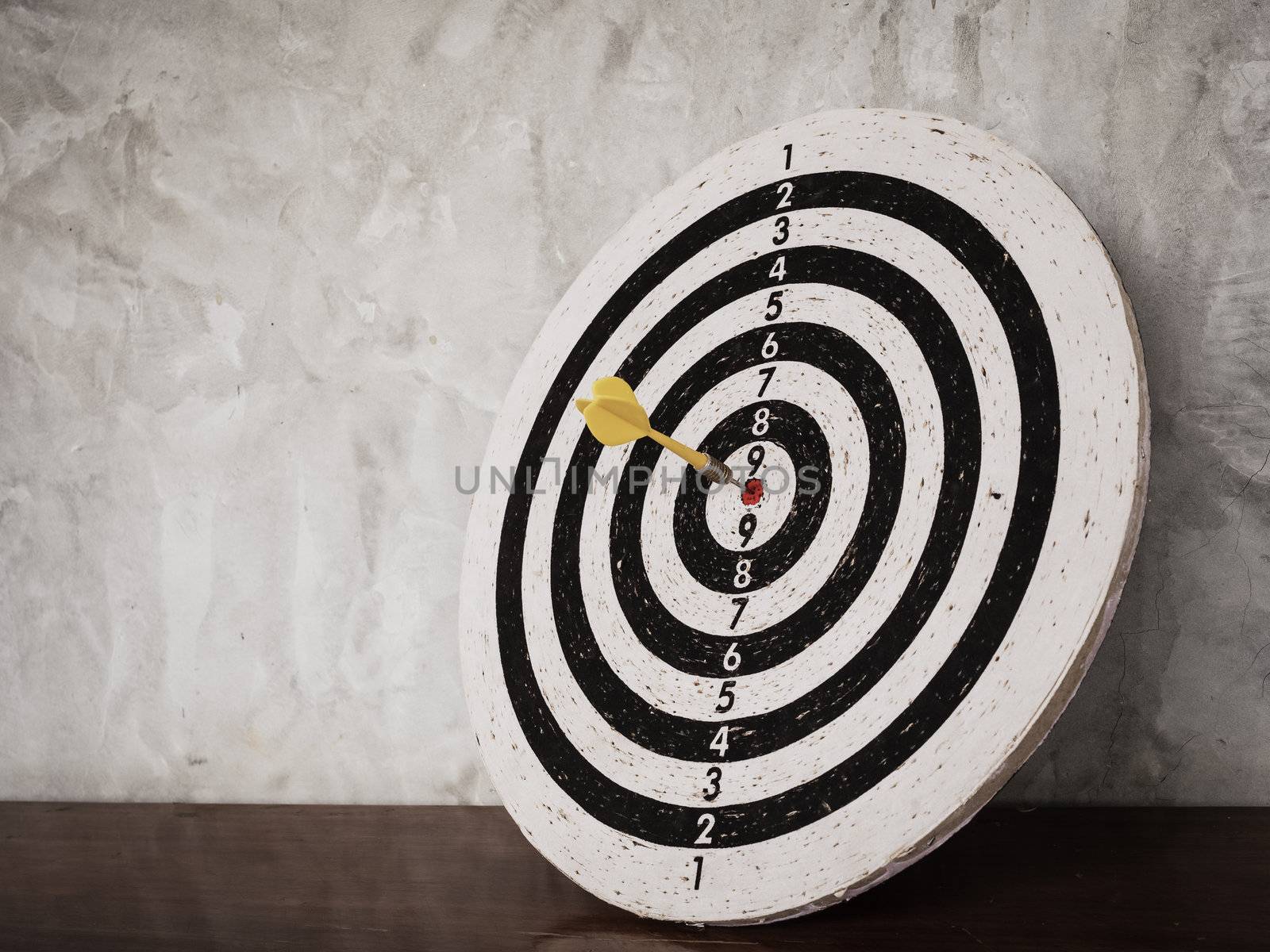 Success concept, darts hit target on dartboard