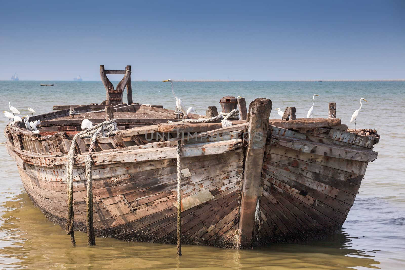 Empty beach, boat in the sea