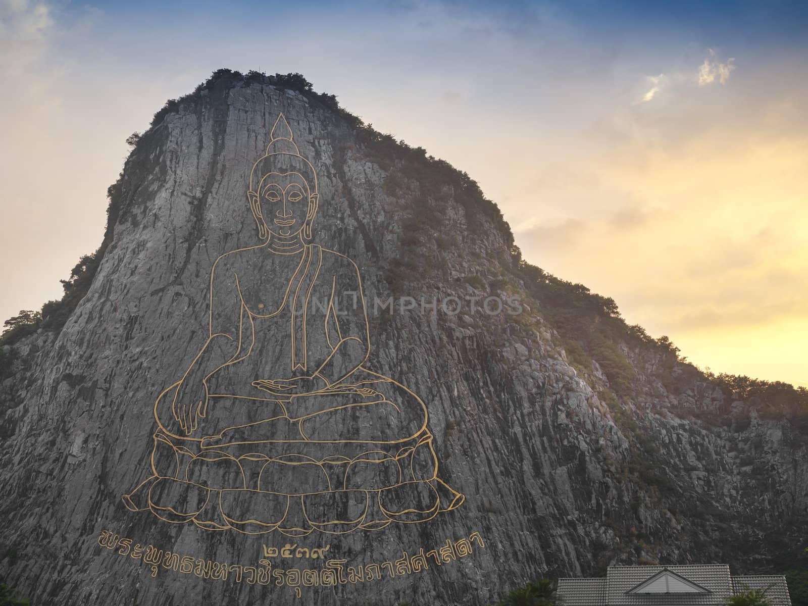 Buddha image carved with laser at the mountain, Thailand