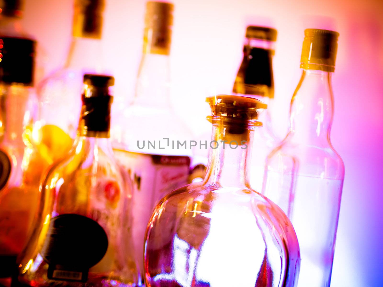 Various bottles at a bar arranged in rows