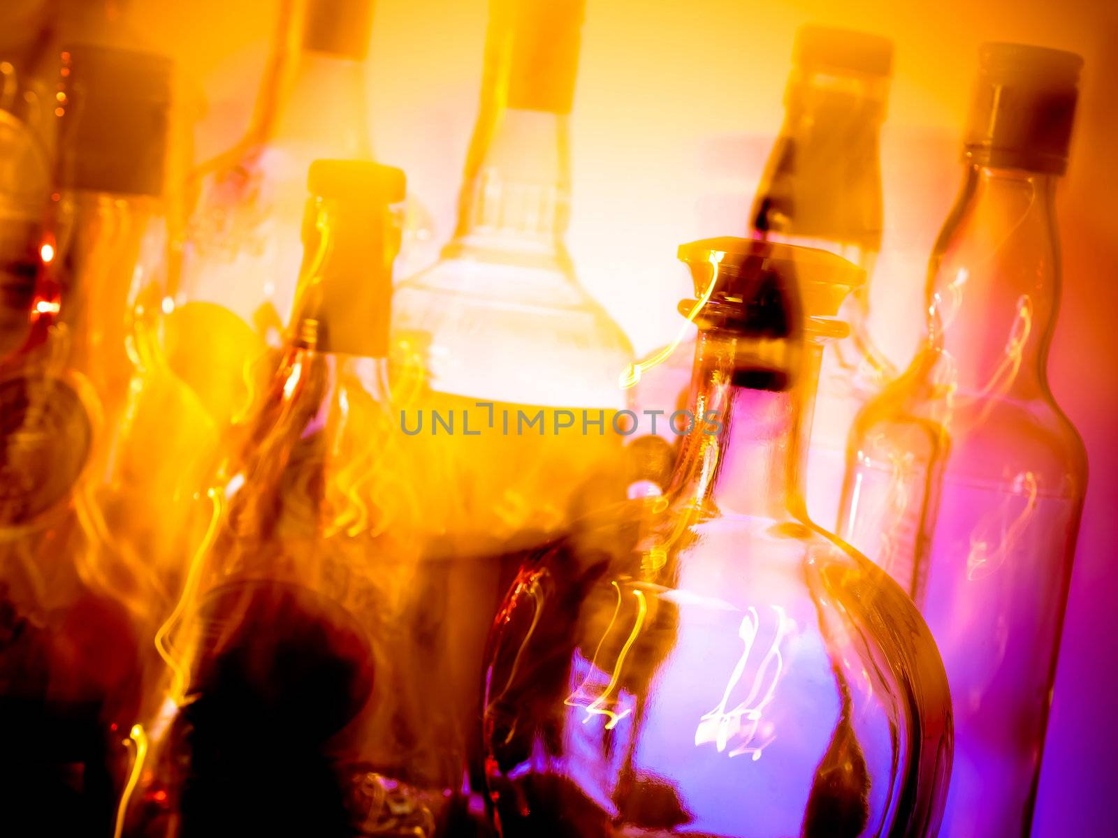 Various bottles at a bar arranged in rows, motion blur