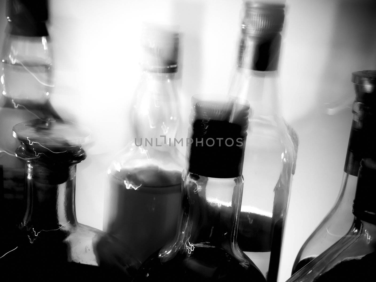 Various bottles at a bar, black and white, high contrast