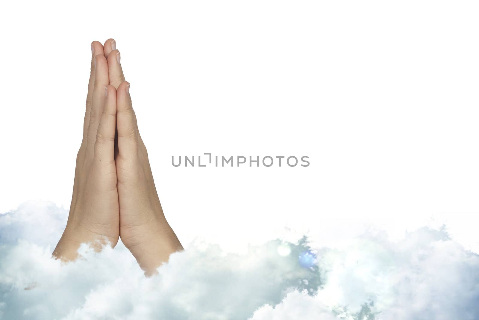 Praying woman hands with mystic holly clouds 