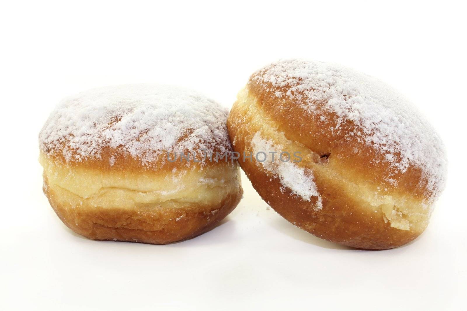 two fresh donuts on a white background