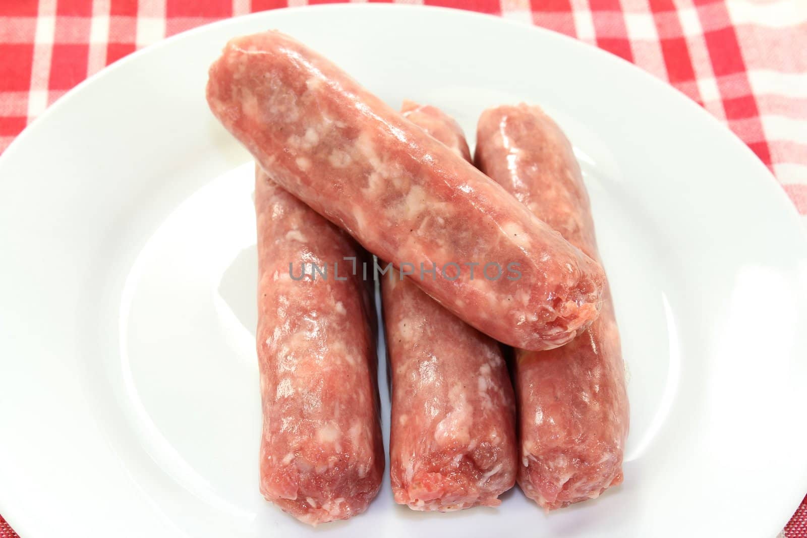 raw fried sausage on a white plate