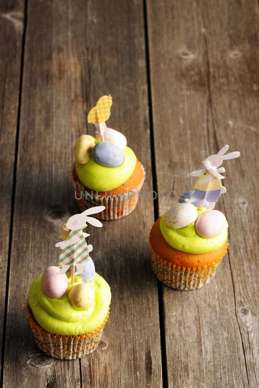 Easter homemade cupcakes over wooden table