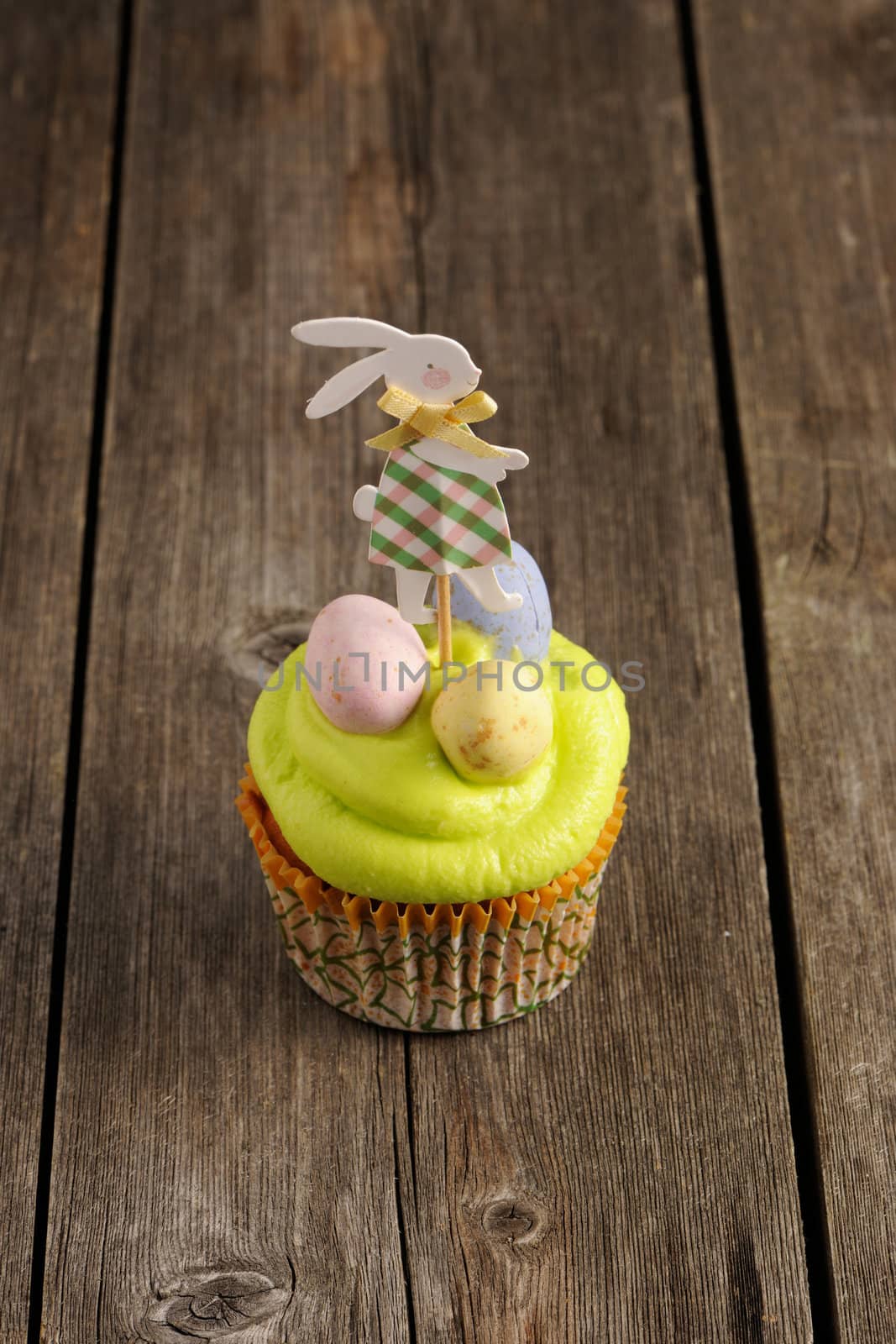 Easter homemade cupcake over wooden table