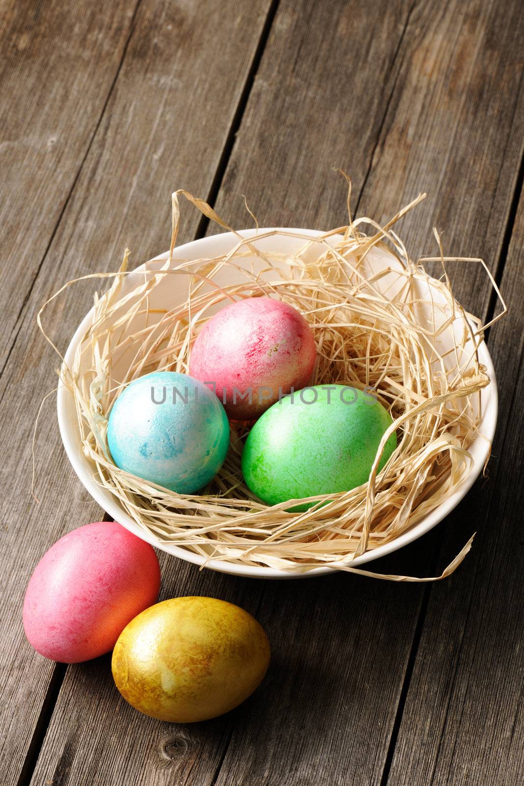 Colored easter eggs in nest by haveseen