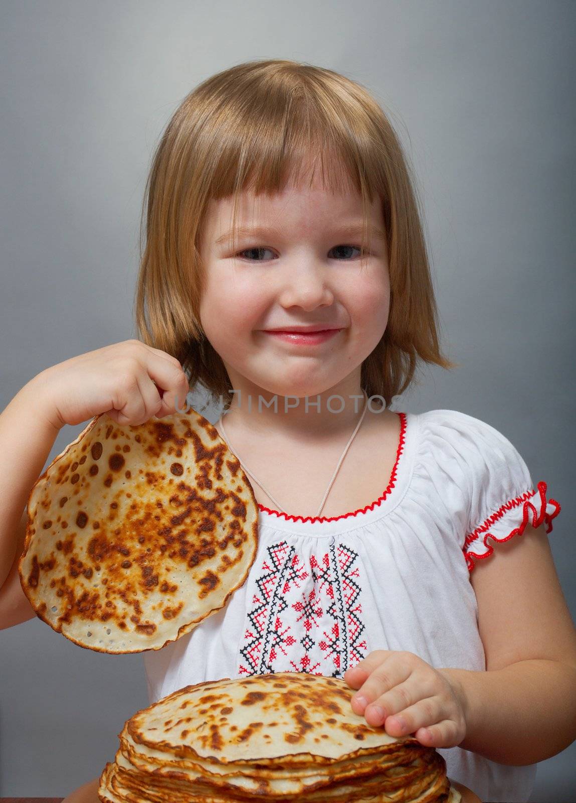little girl eats pancakes by Fanfo