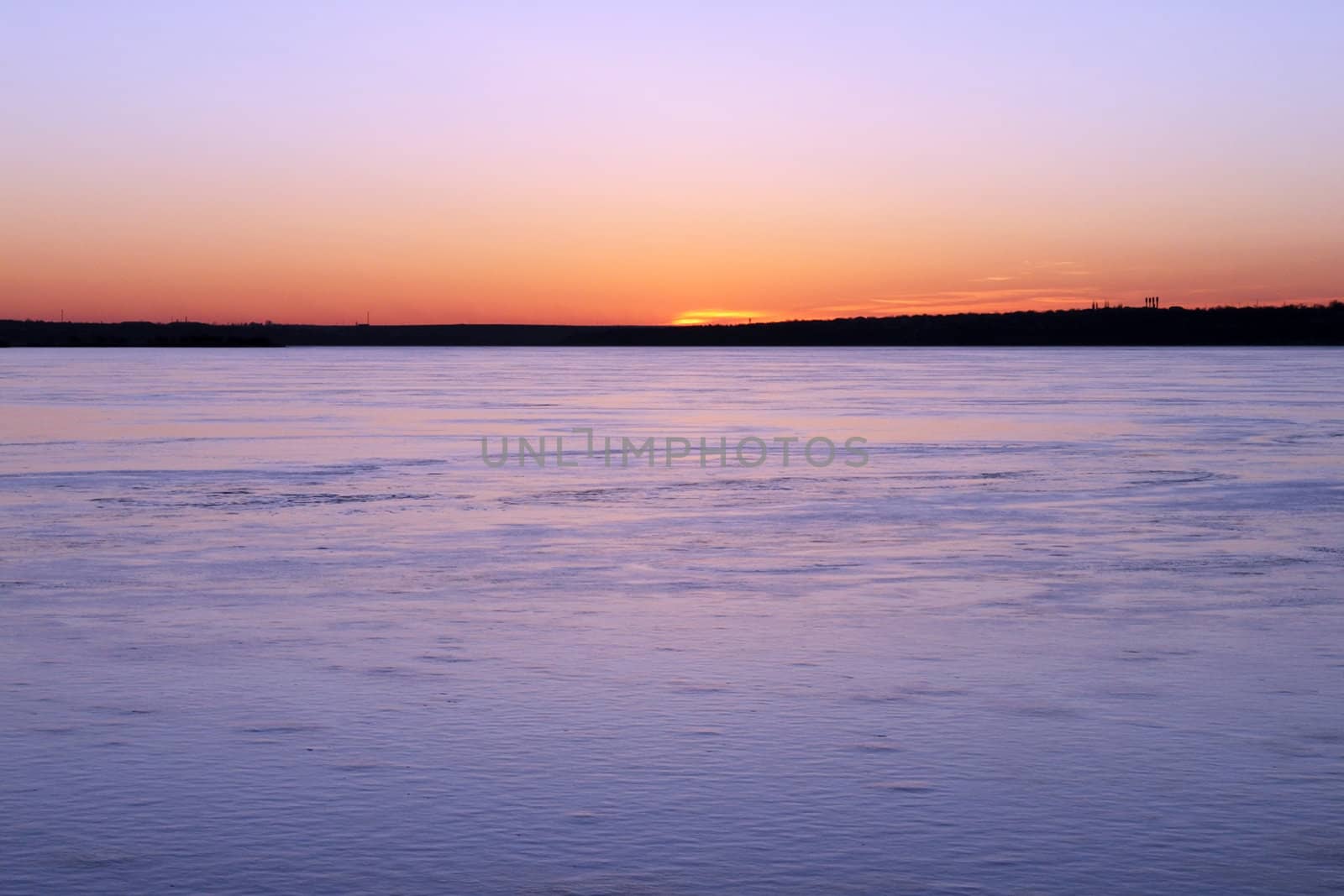 sunset over frozen river