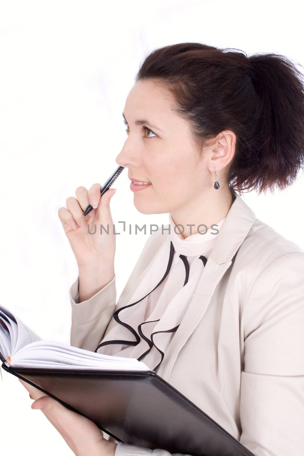Thoughtful young girl holding pen and notepad, isolated on white background