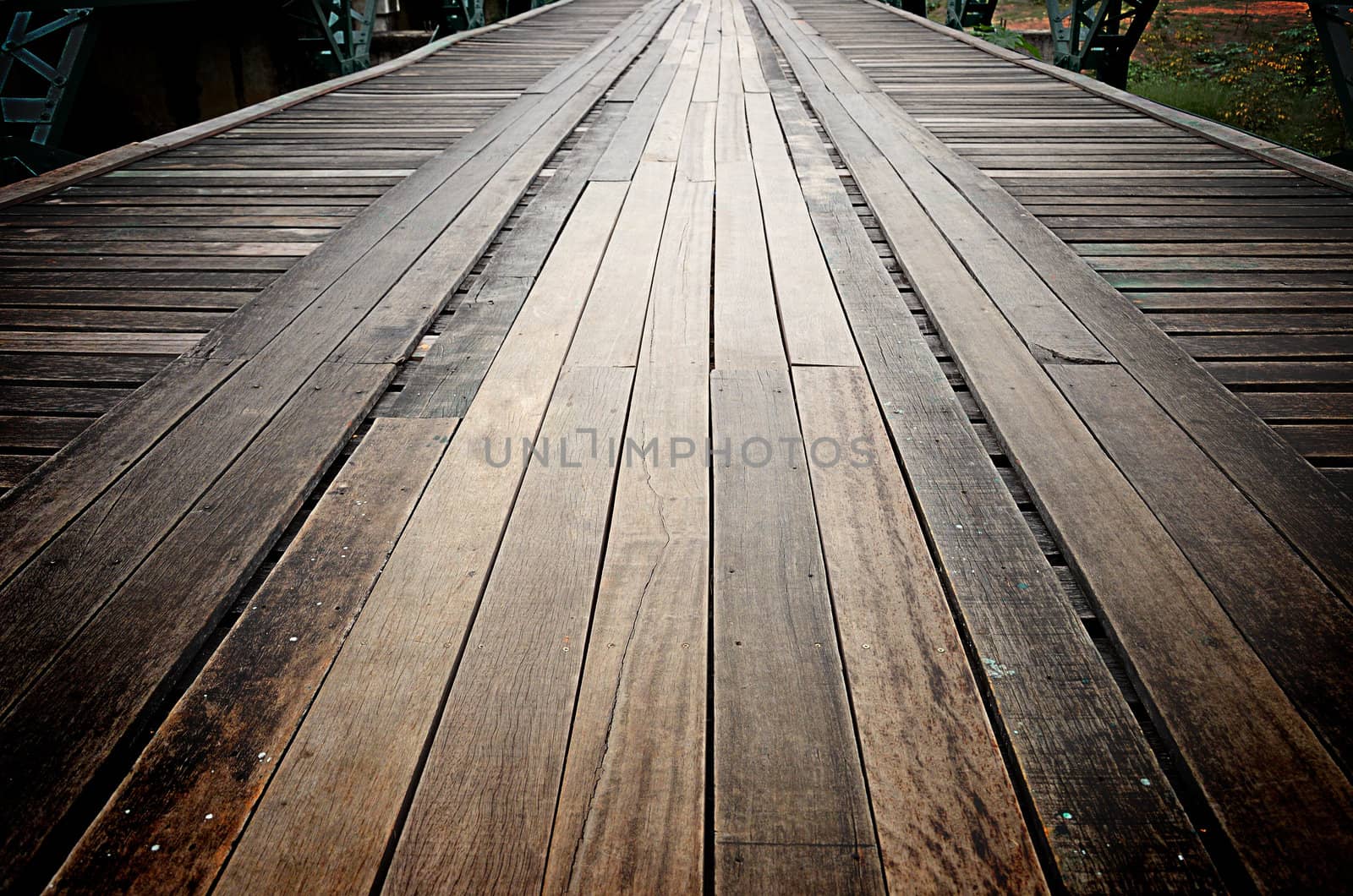 Old wooden road on the metal bridge