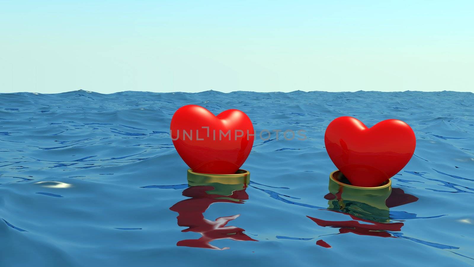 Hearts in gold wedding rings float at the ocean on a meeting each other.