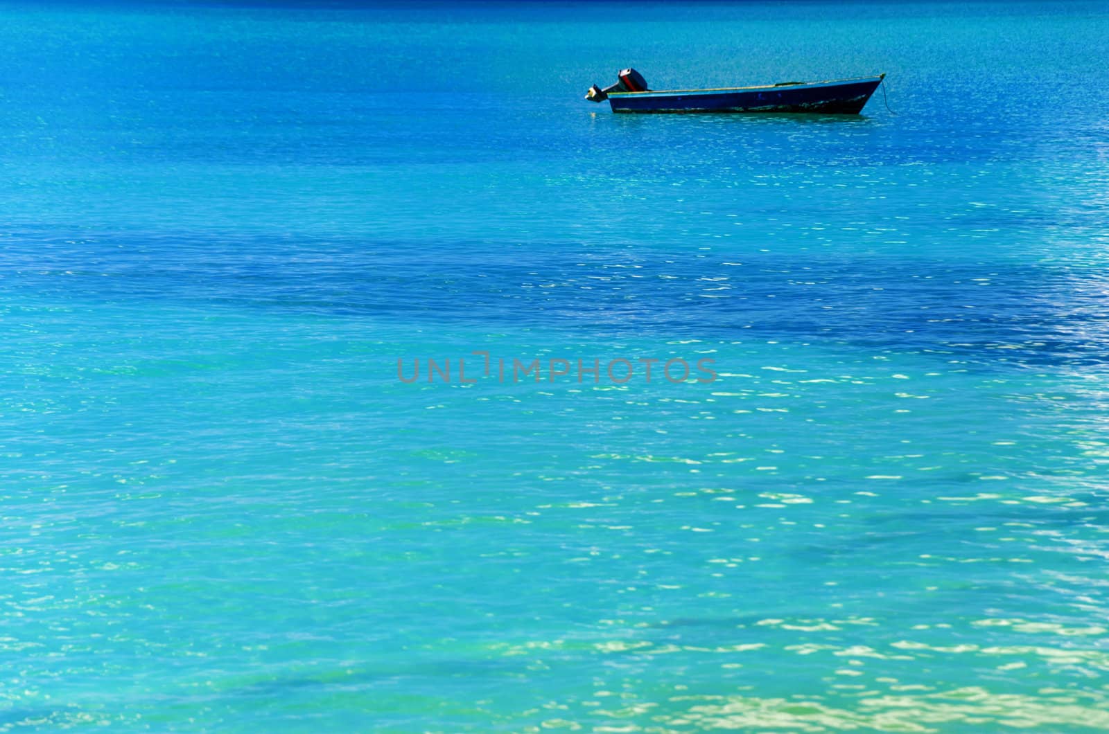 Blue boat in turquoise Caribbean water in San Andres y Providencia, Colombia