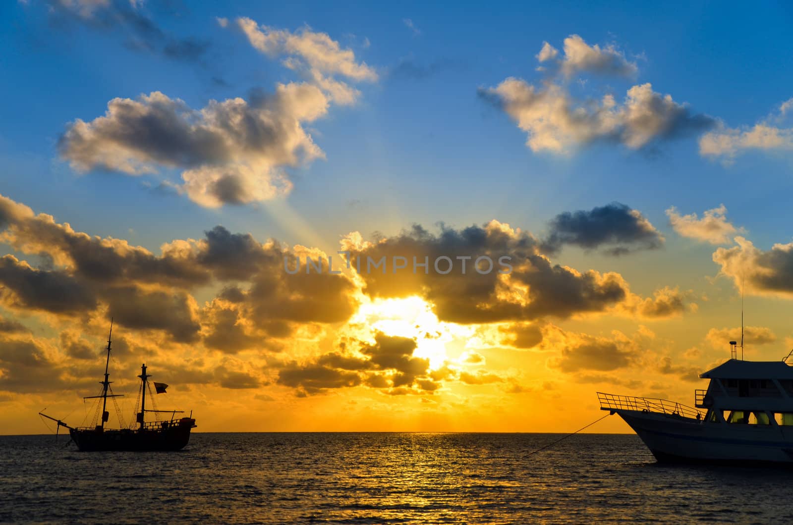 Blue and orange sunrise over a pirate ship in the Caribbean Sea near San Andres, Colombia