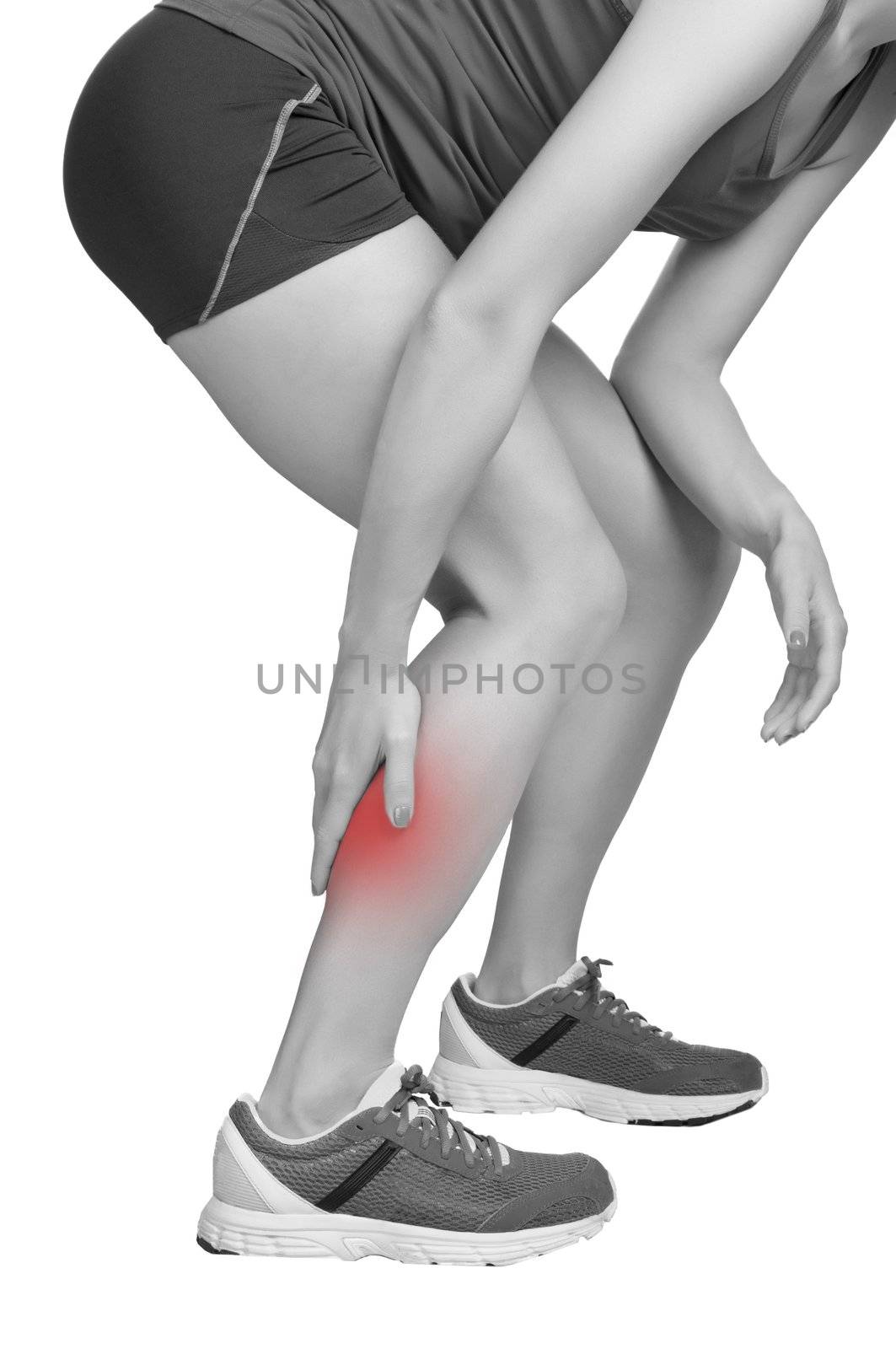 Female jogger with pain in her lower leg, black and white, isolated in white