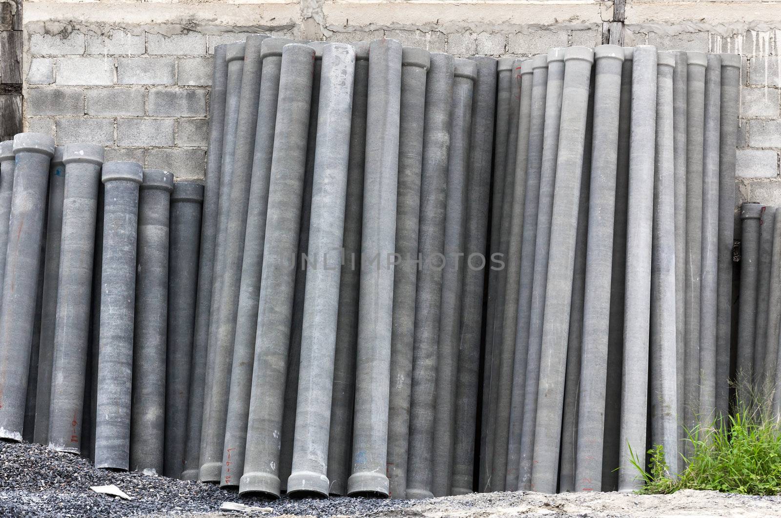 Stack of many concrete drainage pipe on wall  in construction site