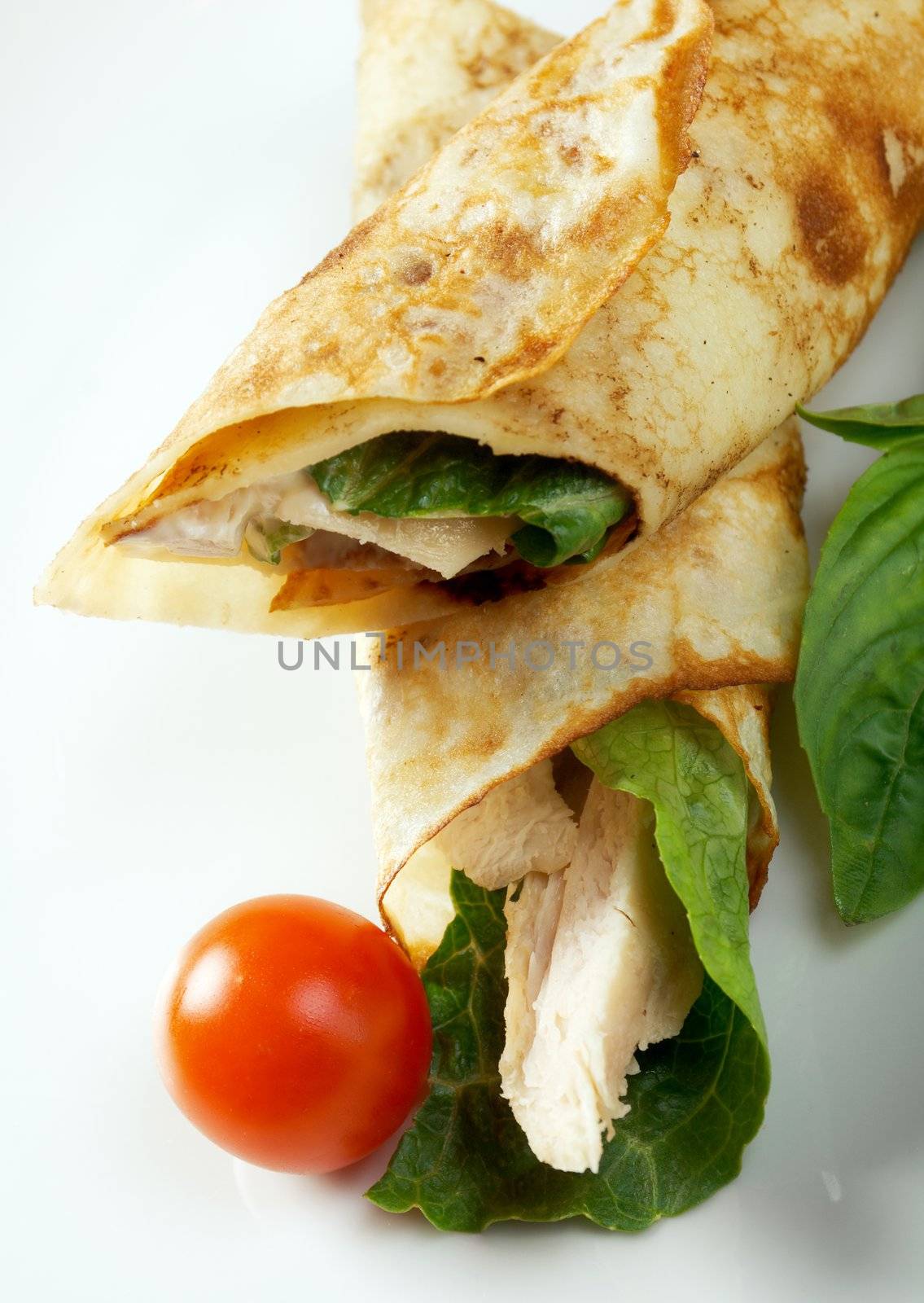 rolled pancakes stuffed chicken. Shallow depth-of-field.