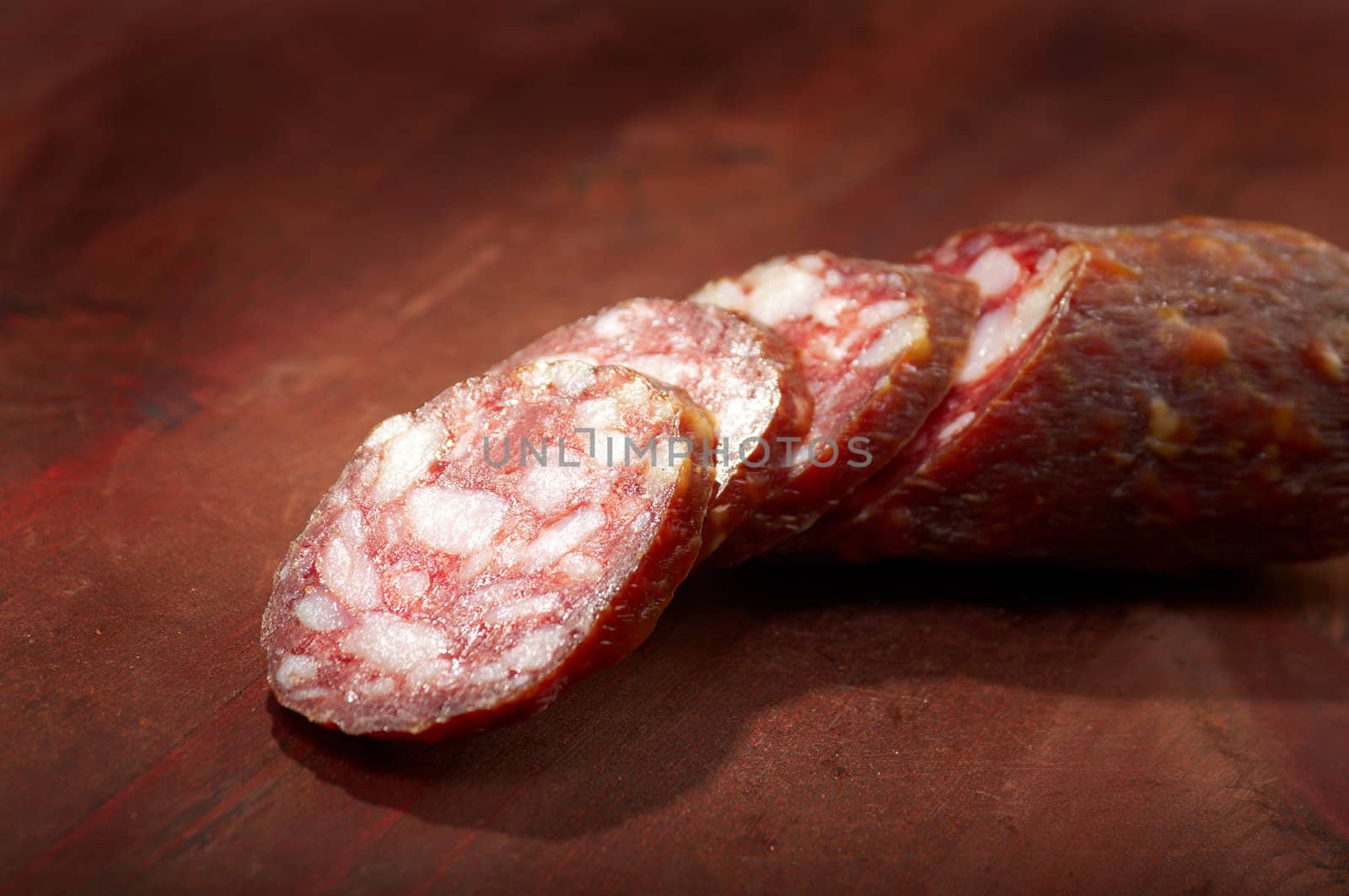 Sliced salami  on rustic wooden table, selective focus