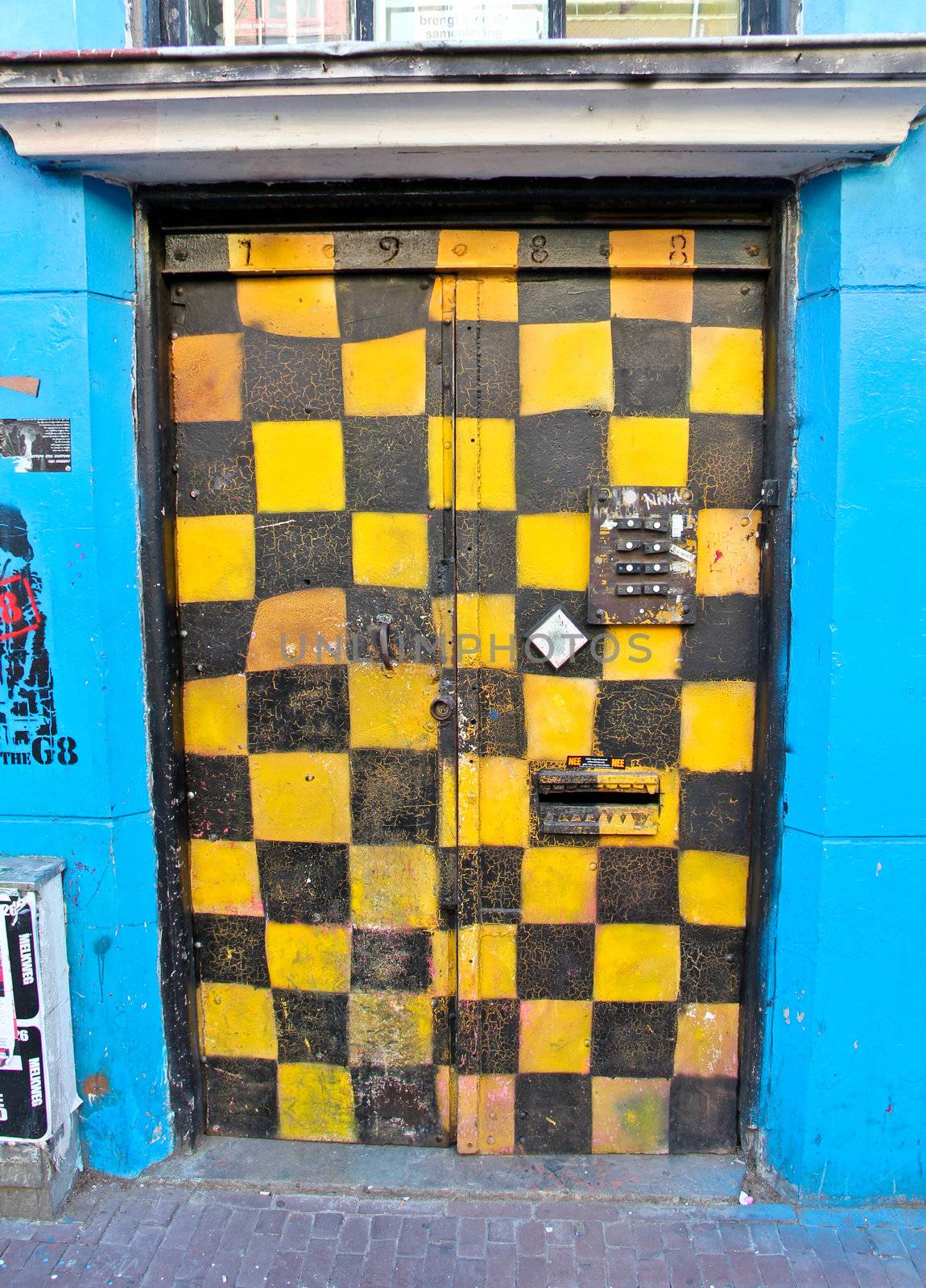 Black and yellow squares graffiti in doorway in Spuistraat, Amsterdam.