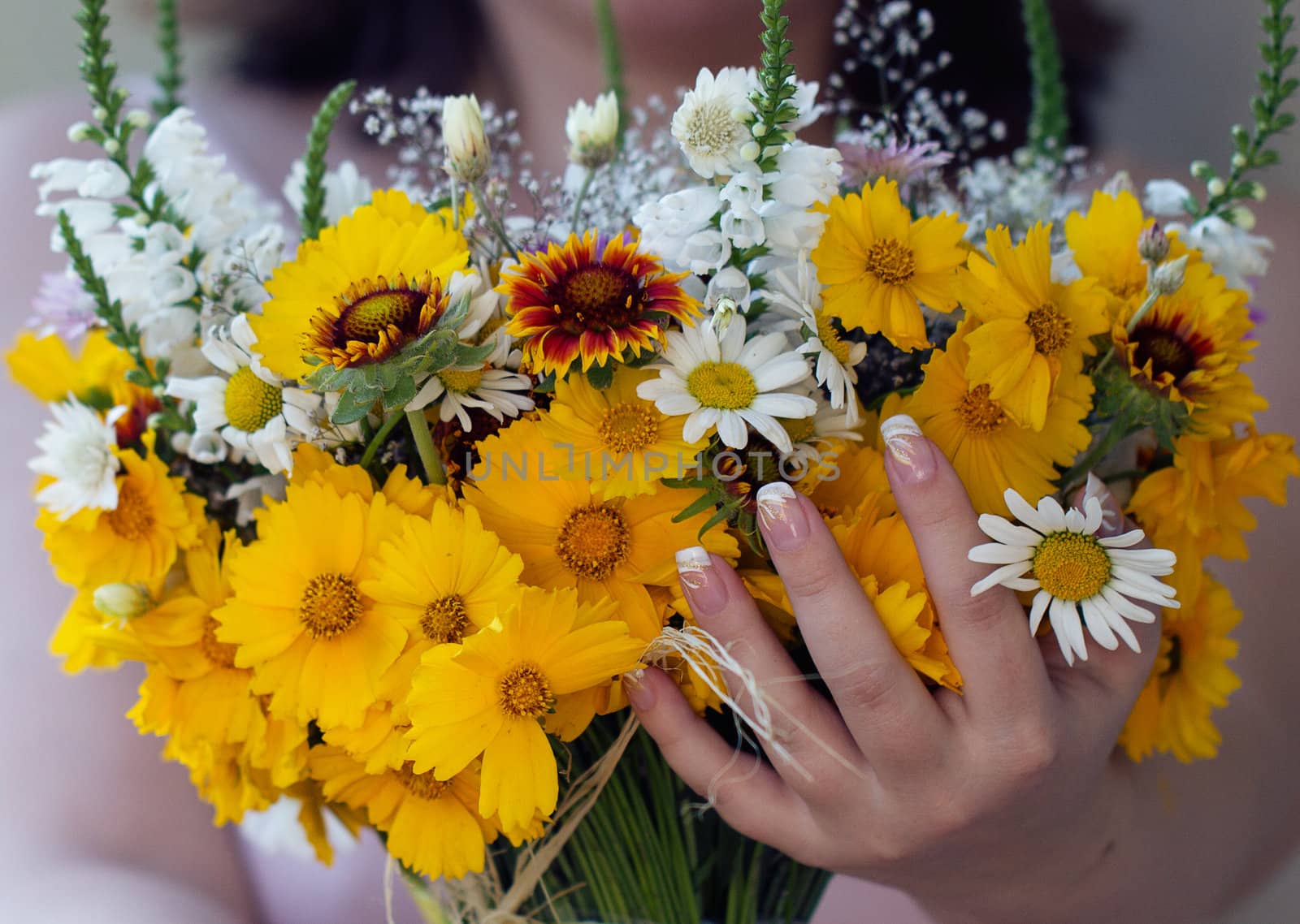 Arm with yellow wild flowers