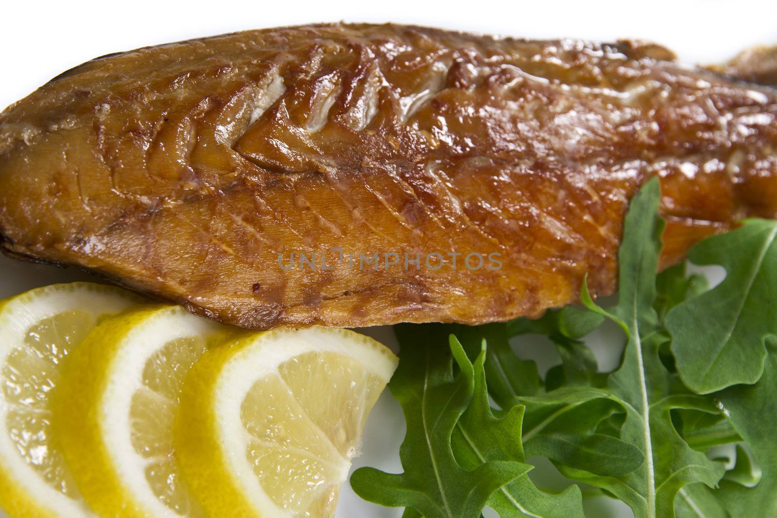 Smoked mackerel fish with lemon and salad