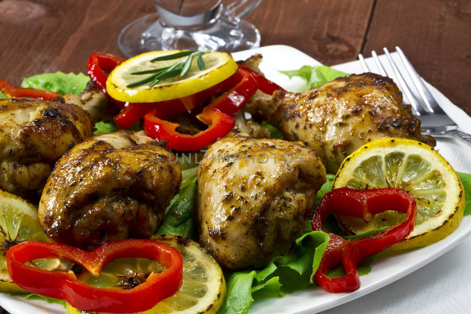 Fried chicken drumsticks with lemon and red peppers