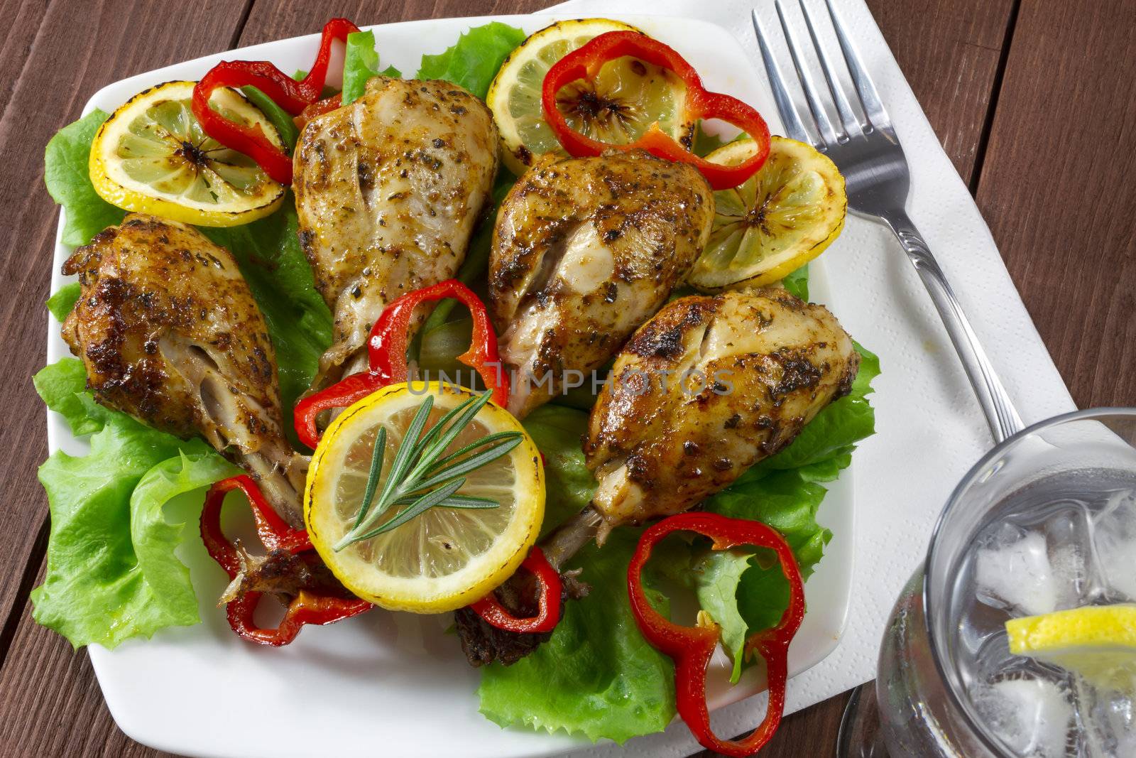 Fried chicken drumsticks with lemon and red peppers