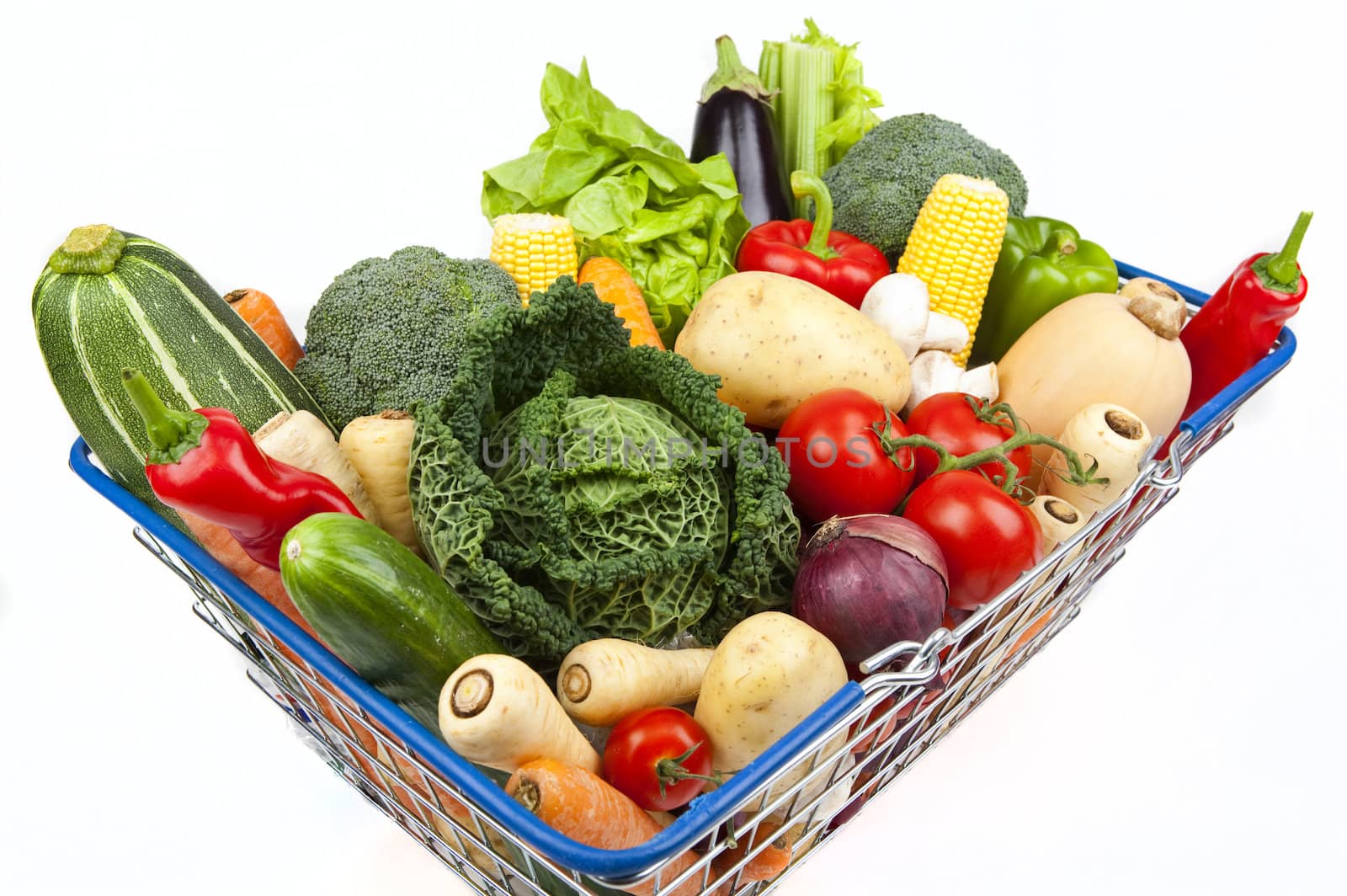 A shopping basket full of Vegetables on a white background.