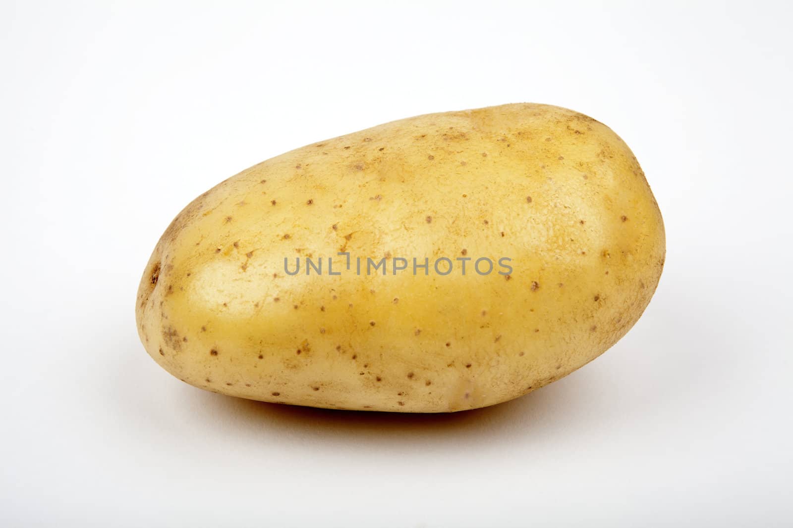 A solitary Potato on a white background.