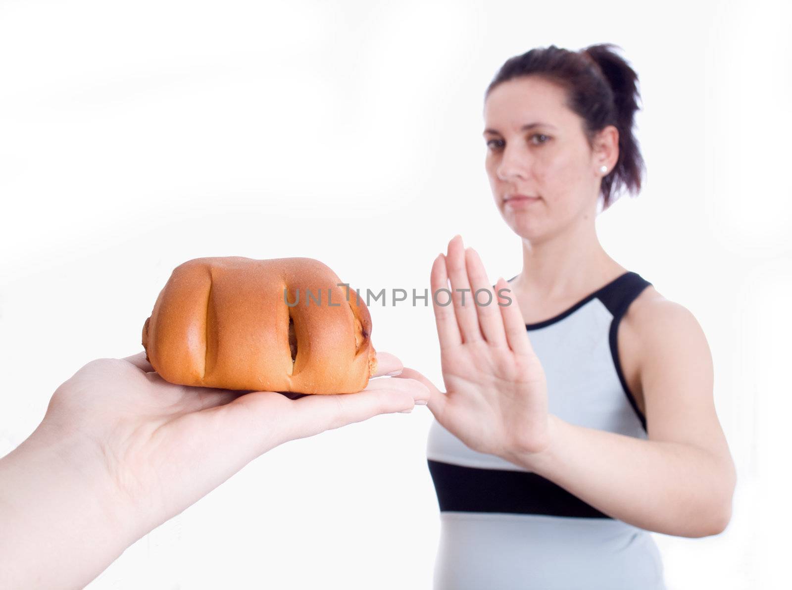 Woman refuses muffins isolated on white background