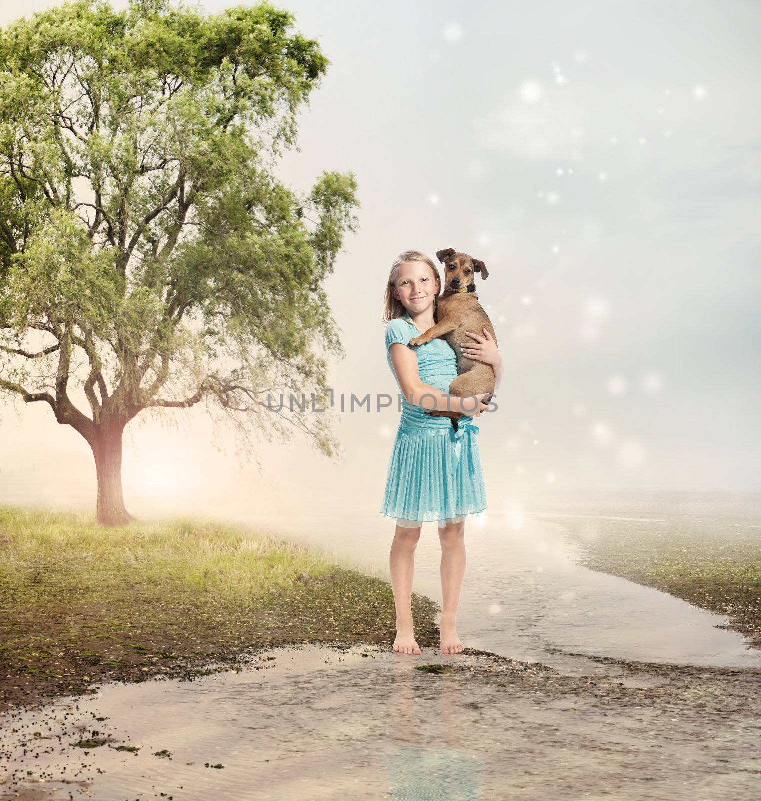 Young Blonde Girl Holding her Puppy at a Magical Brook