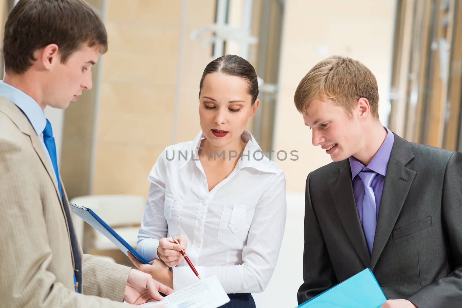 Business people discussing reports that are in the office, focus on woman