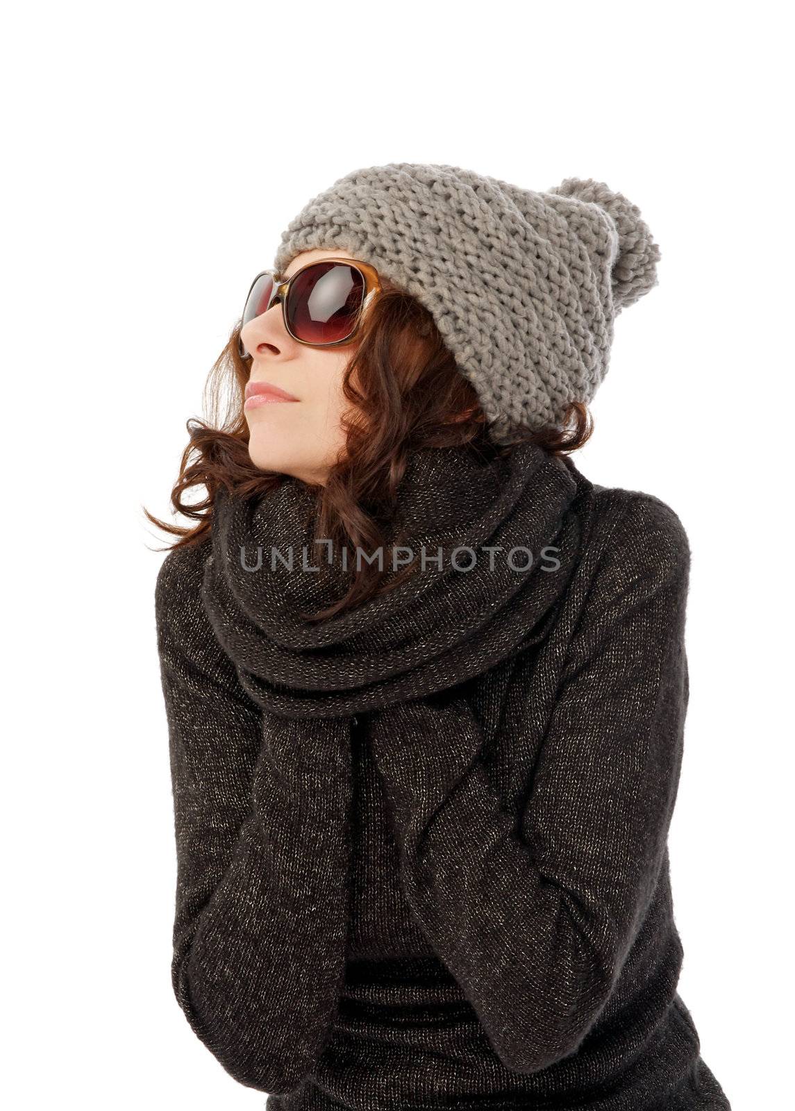Beautiful Girl in Knitted Hat and Sunglasses Warms Hands into her Warm Sweater closeup on white background