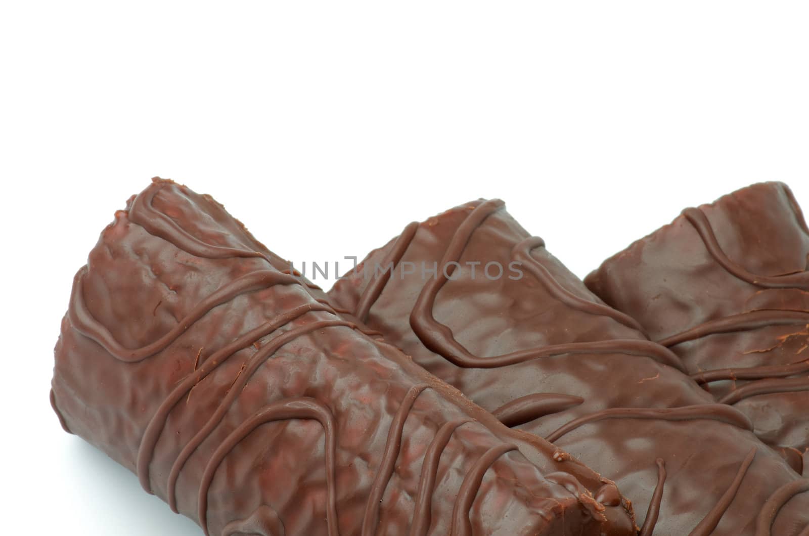 Delicious Biscuit Swiss Rolls  with Decorated Chocolate Glaze closeup on white background