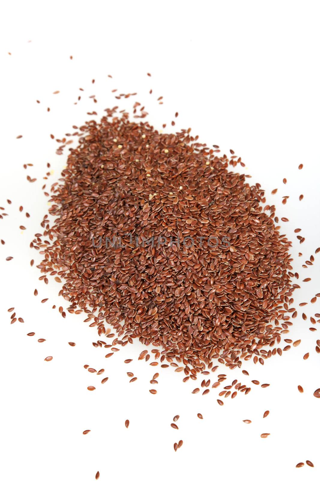 Photograph of flinseed in brown color on white background. Photograph of food grains in brown color on white background.