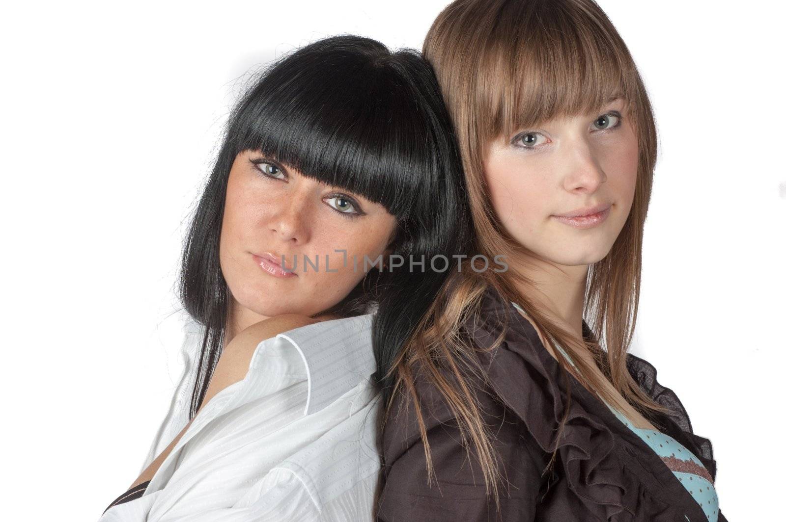 Two smiling attractive girl friends - blond and brunette on white background