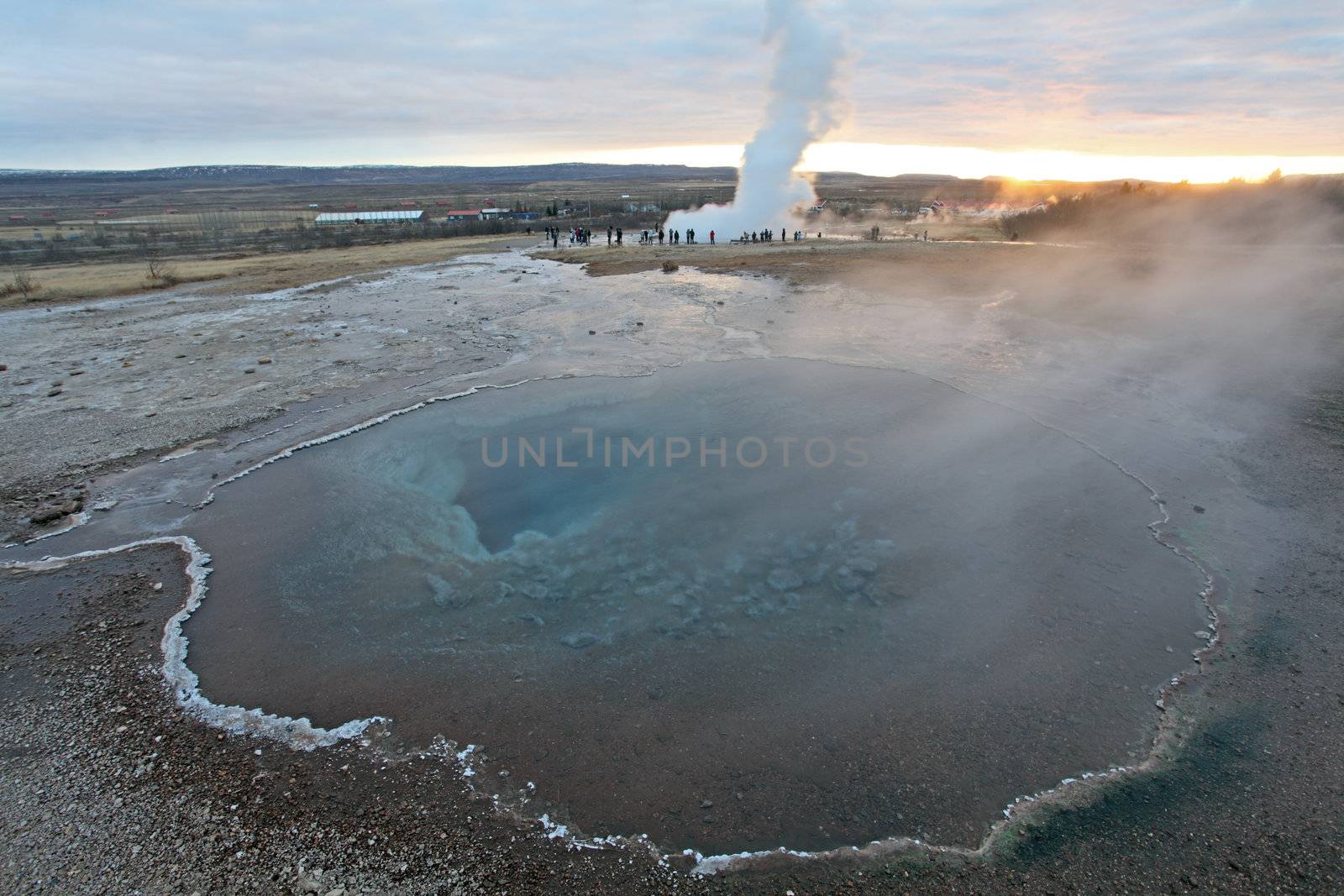 Strokkur Geyser and hot spring in Iceland erupting at sunset in winter