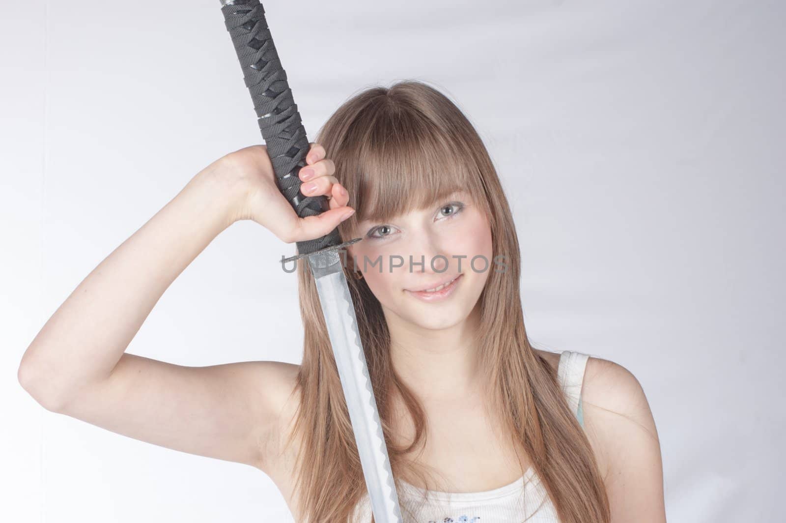 Beautiful blonde lady with japanese sword isolated