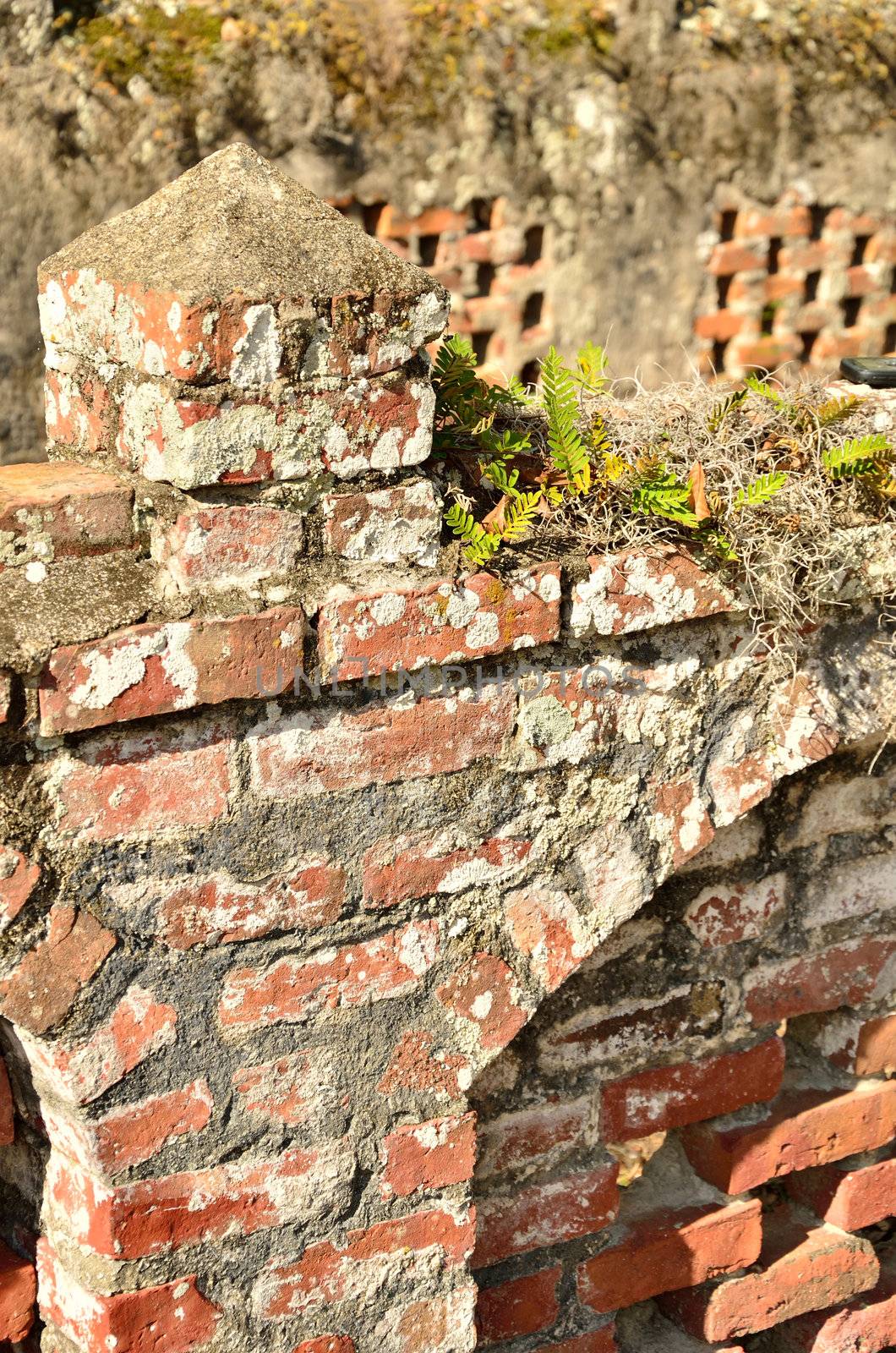 Old brick fence includes open hole masonry pattern