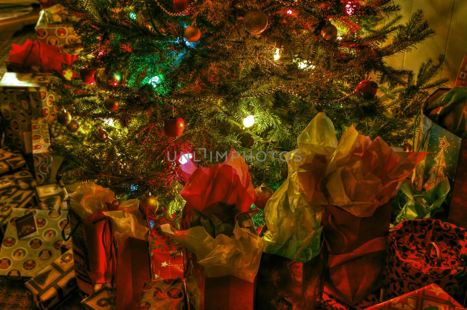 Wraped gifts under a Christmas tree and decorations