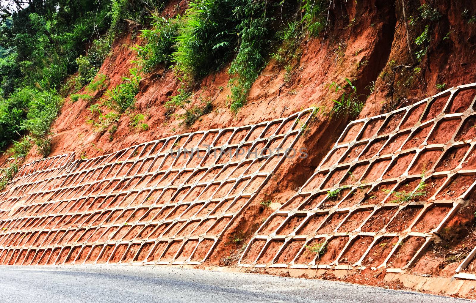 wall protects mountain road from landslides