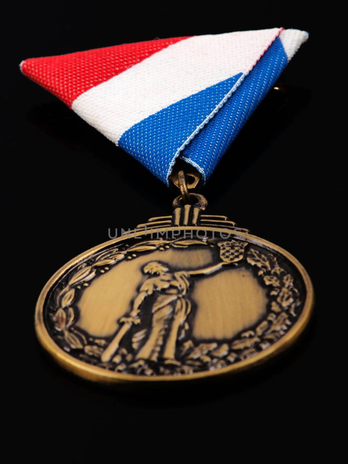 bronze medal for war heroes; isolated on black background        