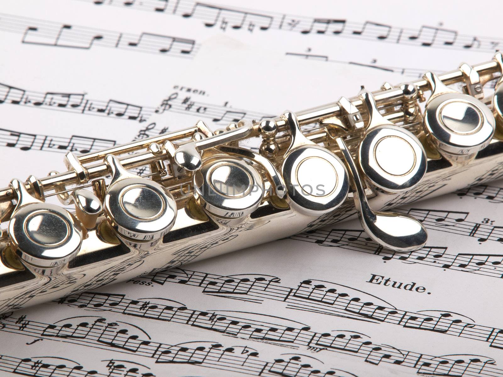  used flute rests across an open musical score. Only one line of music is in focus.