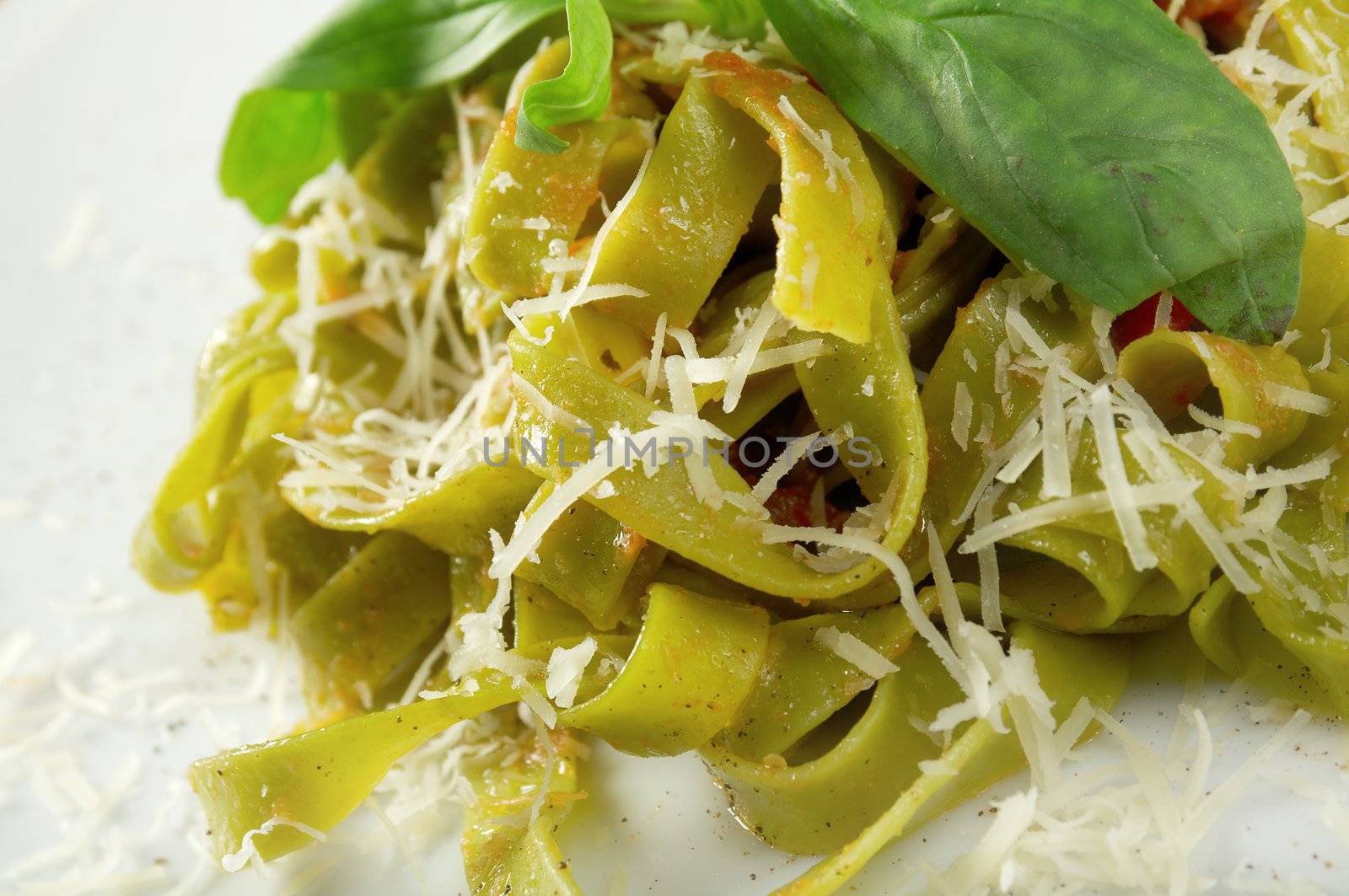 Pasta tagliatelle with pesto sauce basil and grated parmesan